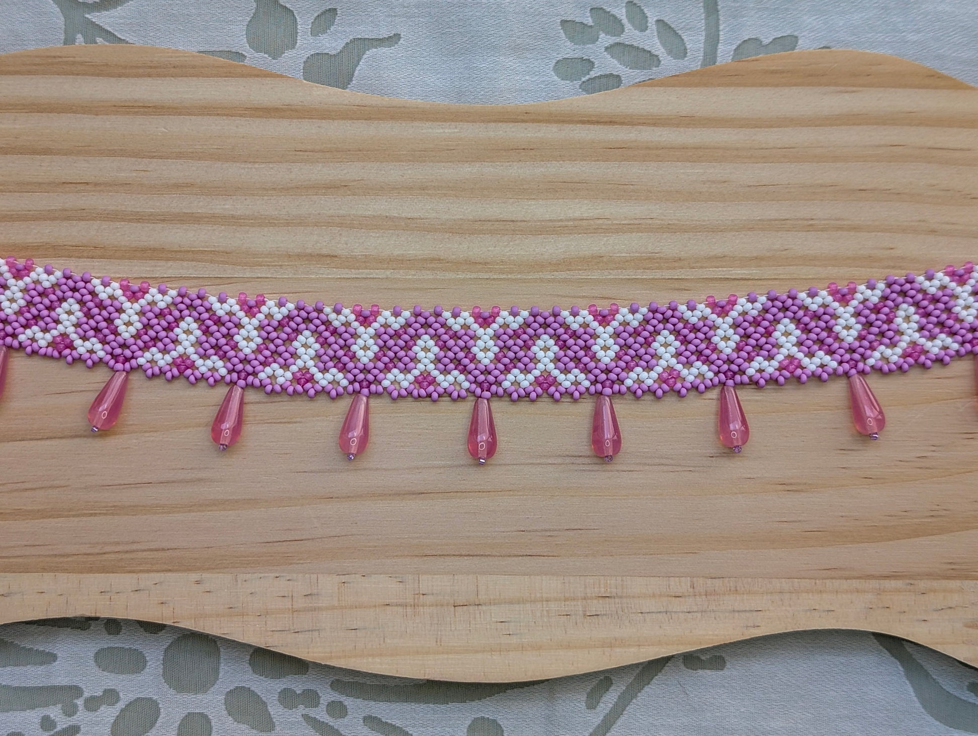 Pink collar necklace with traditional Ukrainian pattern
