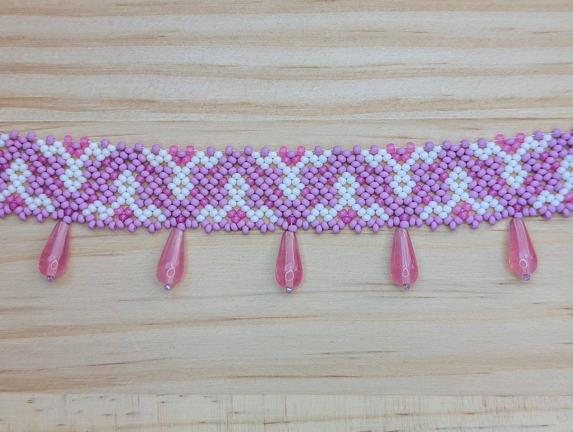 Pink collar necklace with traditional Ukrainian pattern