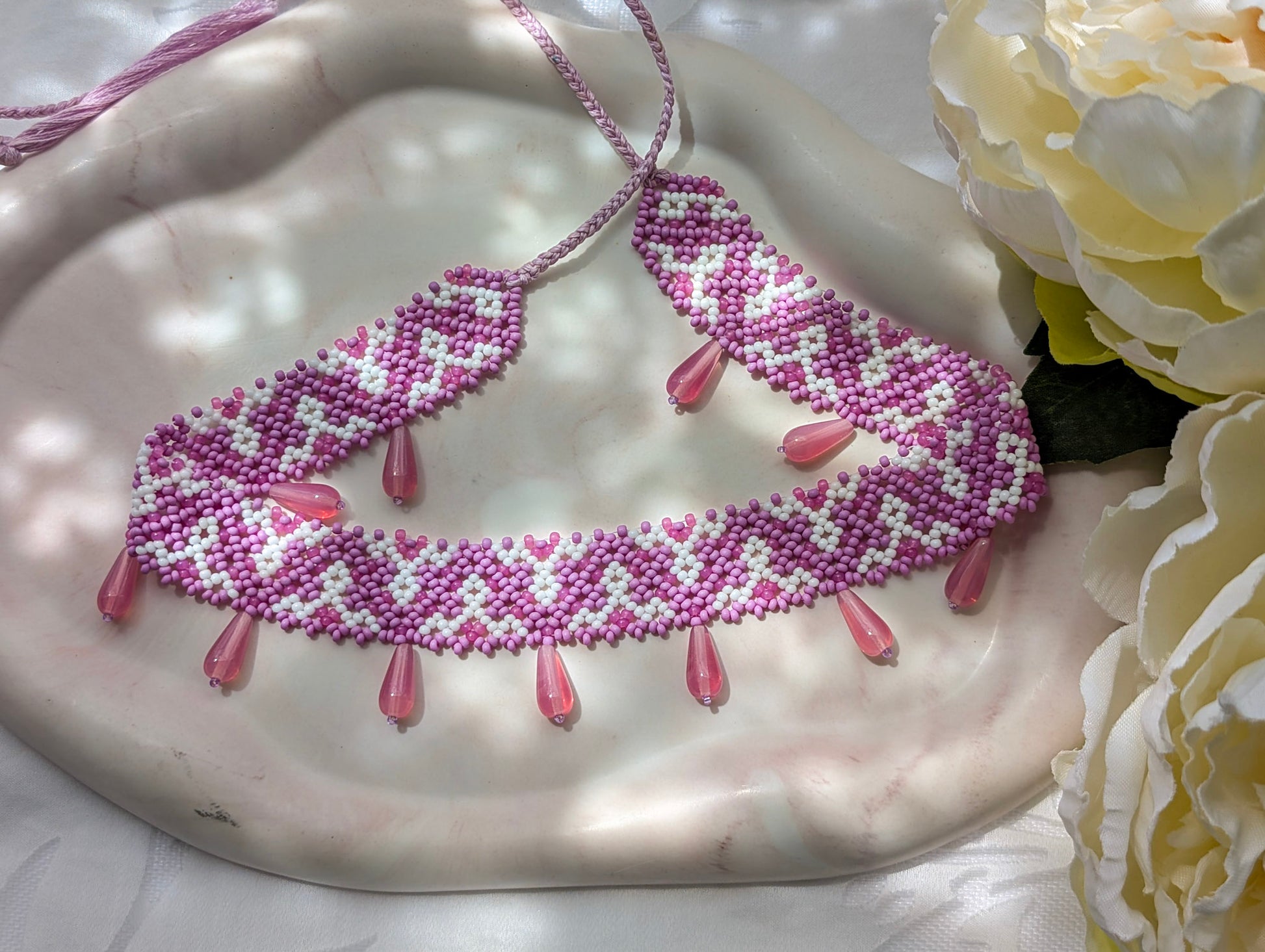 Pink collar necklace with traditional Ukrainian pattern