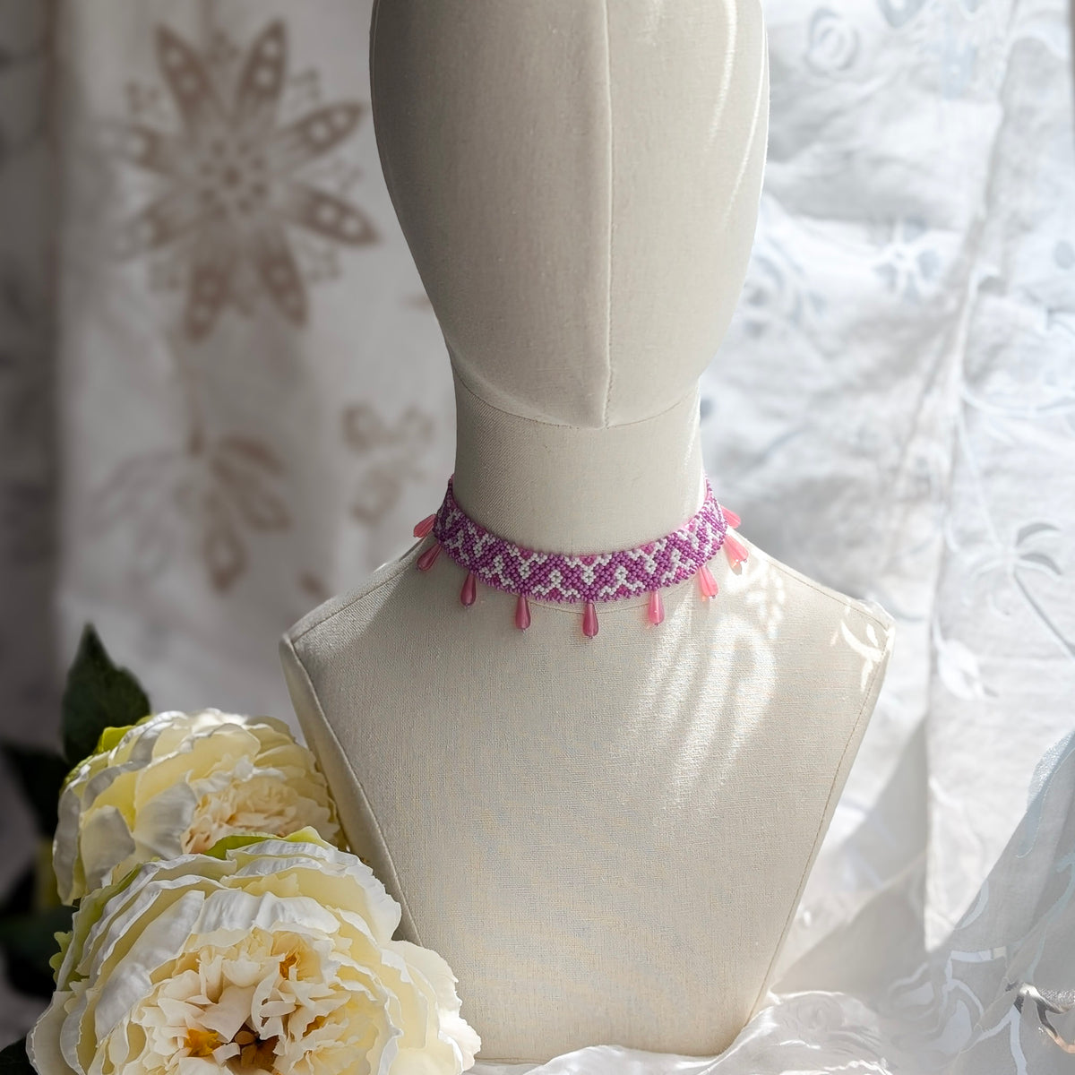 Pink collar necklace with traditional Ukrainian pattern