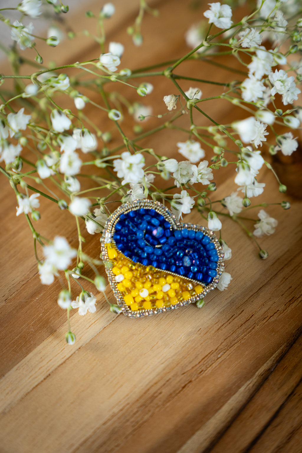 Heart-shaped pin in the colors of the Ukrainian flag