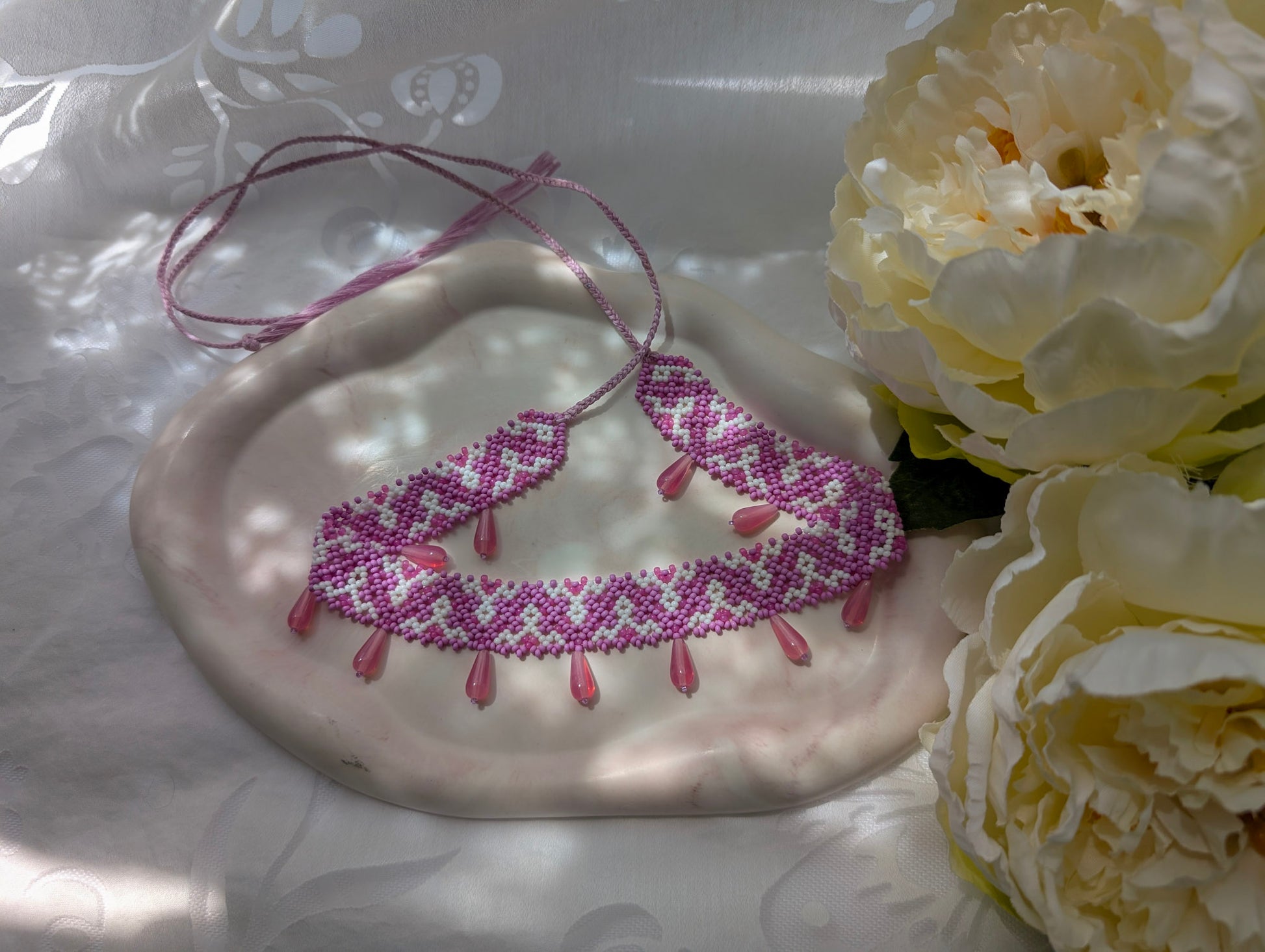 Pink collar necklace with traditional Ukrainian pattern