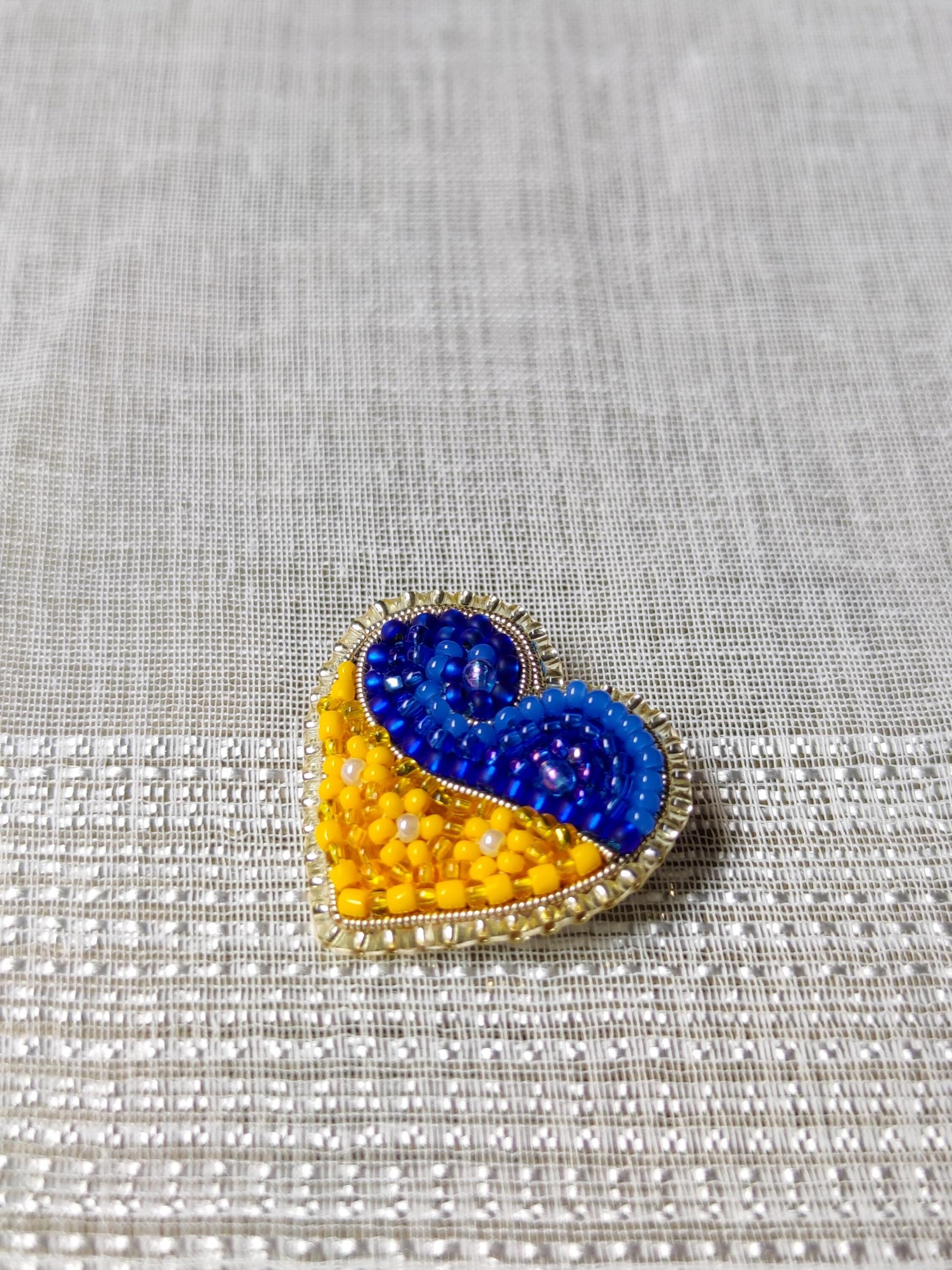 Heart-shaped pin in the colors of the Ukrainian flag