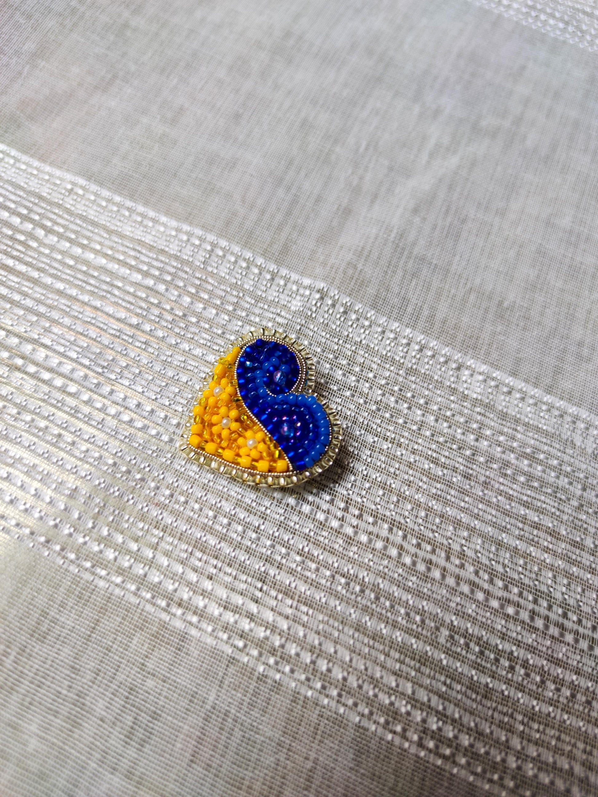 Heart-shaped pin in the colors of the Ukrainian flag